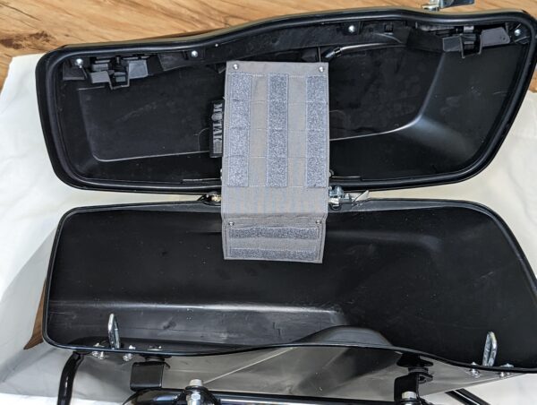 Open motorcycle saddlebag with a TactiTether pouch mounted inside, showcasing organized storage